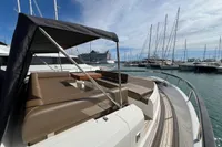 2023 Astondoa AS8 yacht with spacious deck seating in a marina setting.