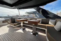 2023 Astondoa AS8 yacht deck with modern seating and tables, overlooking marina.