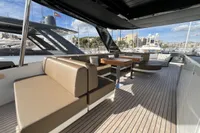 Luxurious 2023 Astondoa AS8 yacht deck with modern seating and scenic marina view.