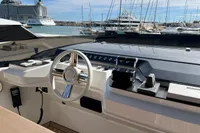 2023 Astondoa AS8 yacht helm with modern controls, docked in a marina.