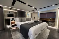 Luxurious bedroom interior of 2023 Astondoa AS8 yacht with modern design and ambient lighting.