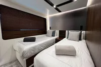 Luxurious 2023 Astondoa AS8 yacht bedroom with twin beds and modern decor.