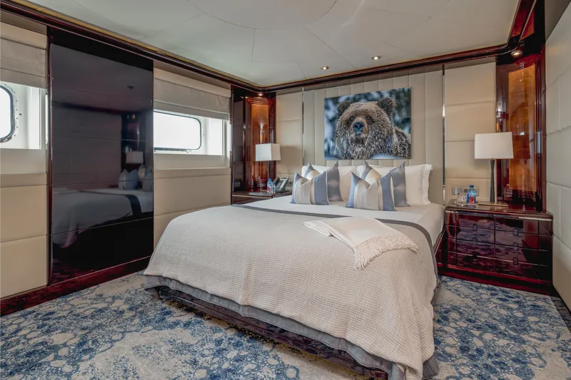 Dream Yacht Photos Pics Luxurious yacht bedroom with elegant decor, featuring a large bed, stylish artwork, and soft lighting.
