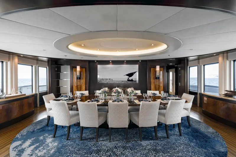 Dream Yacht Photos Pics Luxurious yacht dining room with elegant table setting, panoramic ocean views, and modern decor. Abeking & Rasmussen 6430, 2001.