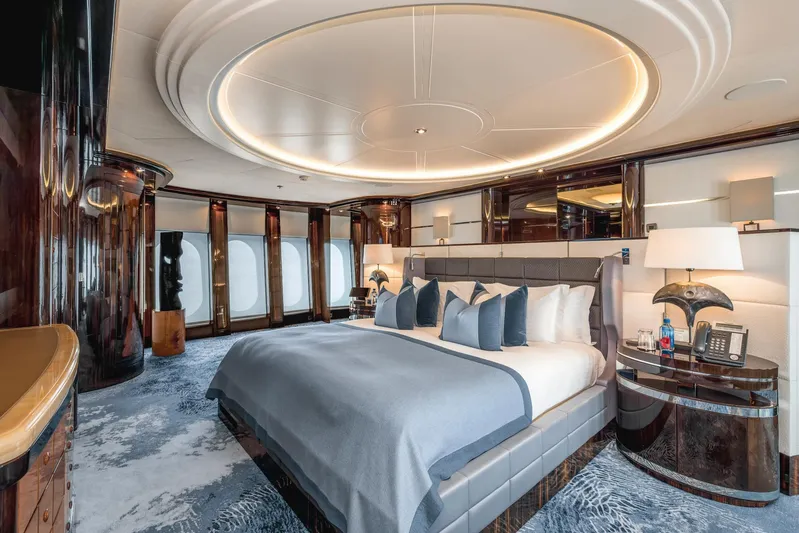 Dream Yacht Photos Pics Luxurious yacht bedroom with elegant decor, featuring a large bed and stylish furnishings, Abeking & Rasmussen 6430.