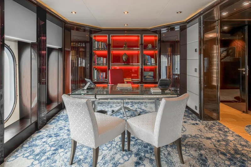 Dream Yacht Photos Pics Luxurious yacht office with modern decor, glass desk, and red-lit bookshelves, Abeking & Rasmussen 6430, 2001.
