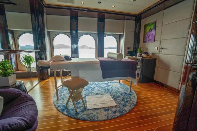 Dream Yacht Photos Pics Luxurious yacht spa room with massage table, ocean view, and elegant decor. Abeking & Rasmussen 6430, 2001.