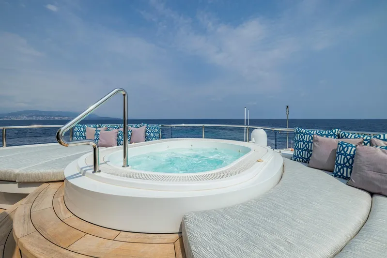 Dream Yacht Photos Pics Luxurious yacht deck with jacuzzi, surrounded by cushions, overlooking the ocean. Abeking & Rasmussen 6430, 2001.