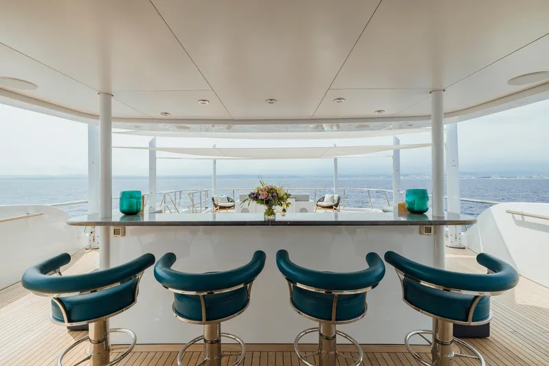 Dream Yacht Photos Pics Luxurious yacht bar with teal stools, ocean view; Abeking & Rasmussen 6430, 2001 model.