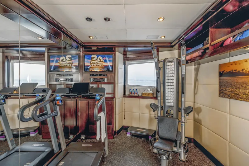 Dream Yacht Photos Pics Luxurious yacht gym with modern equipment, mirrors, and scenic ocean view. Abeking & Rasmussen 6430, 2001.