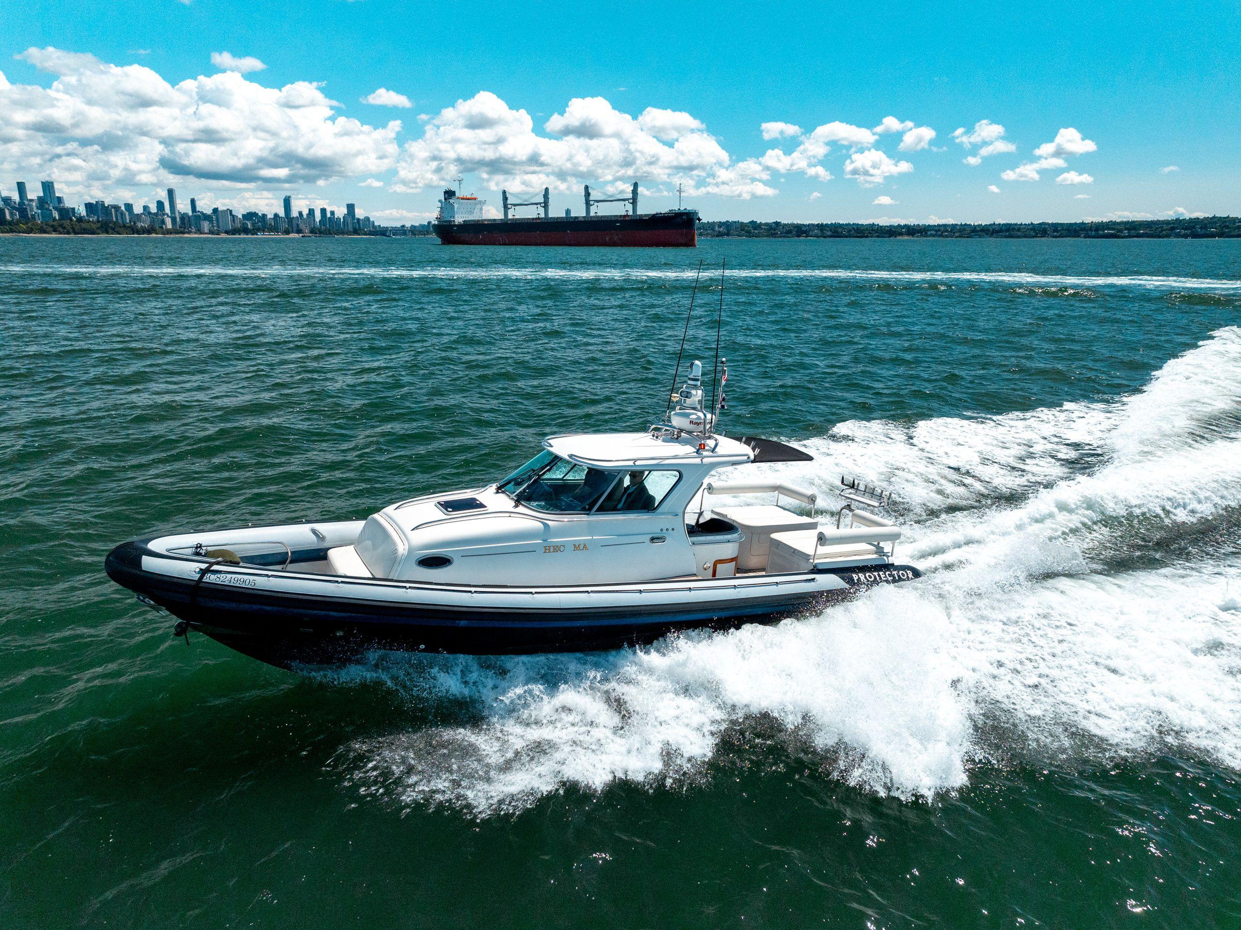2009 Protector Targa 35 boat cruising on open water with city skyline in background.