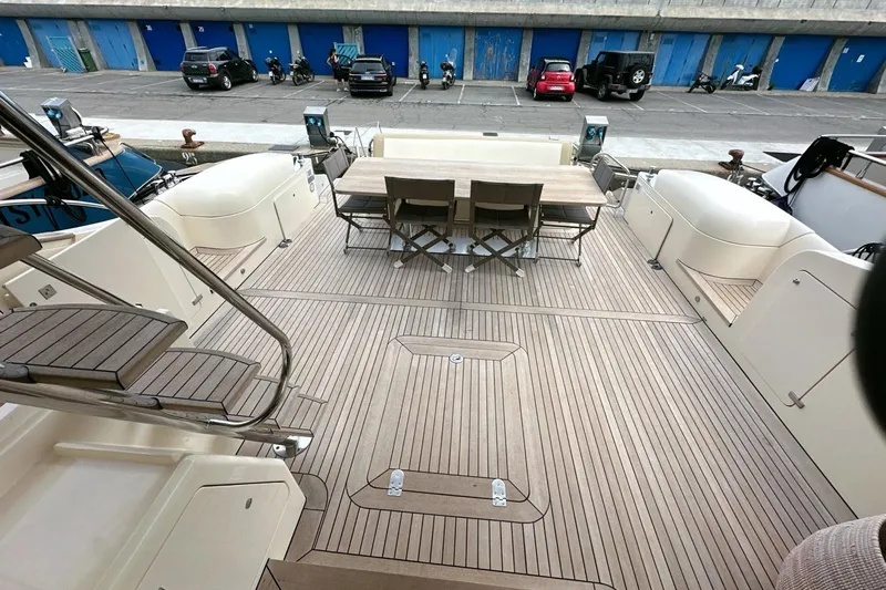  Yacht Photos Pics Spacious deck of 2010 Abati Yachts 64 Freeport with outdoor seating and wooden flooring.