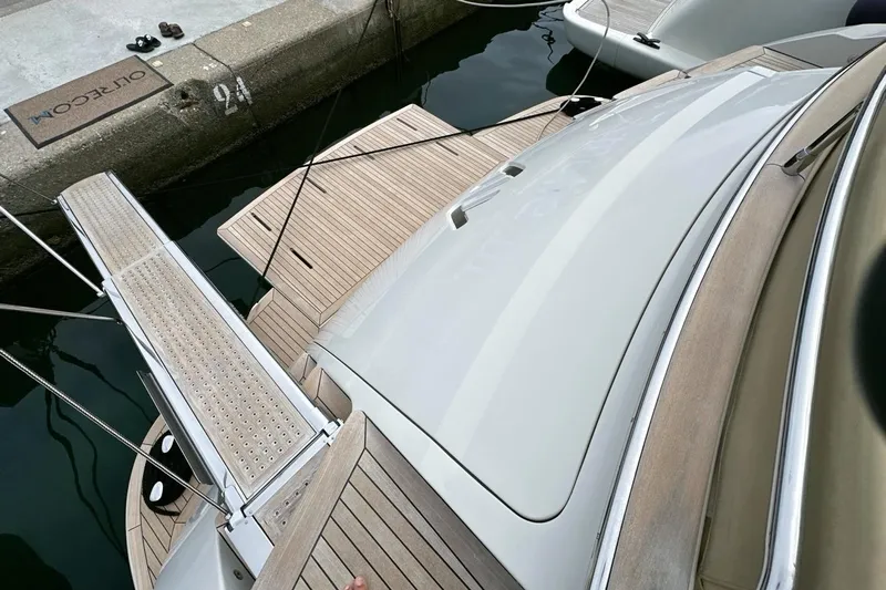  Yacht Photos Pics 2010 Abati Yachts 64 Freeport docked, showcasing sleek design and wooden deck details.