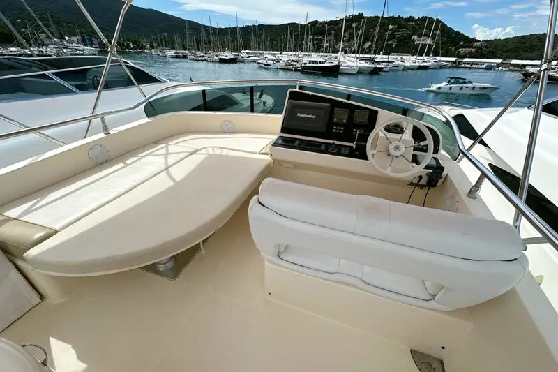  Yacht Photos Pics 2010 Abati Yachts 64 Freeport helm with seating, overlooking marina and sailboats.