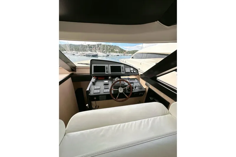  Yacht Photos Pics 2010 Abati Yachts 64 Freeport helm with modern controls and marina view.