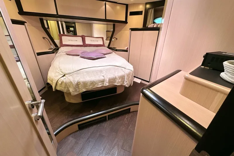  Yacht Photos Pics Luxurious bedroom interior of 2010 Abati Yachts 64 Freeport with elegant wood finishes.