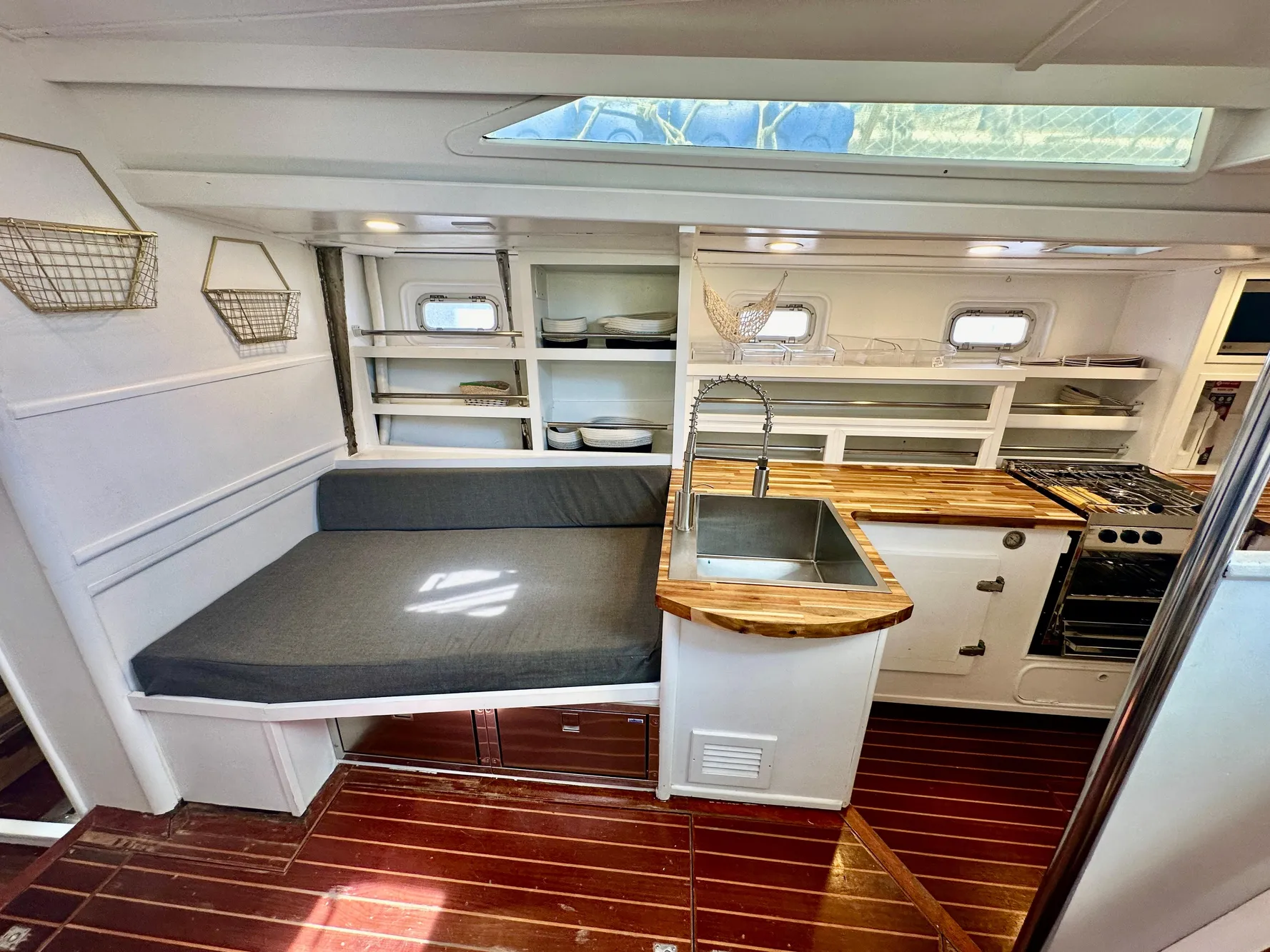 Interior of 1983 Tayana 55 yacht with modern kitchen and seating area.