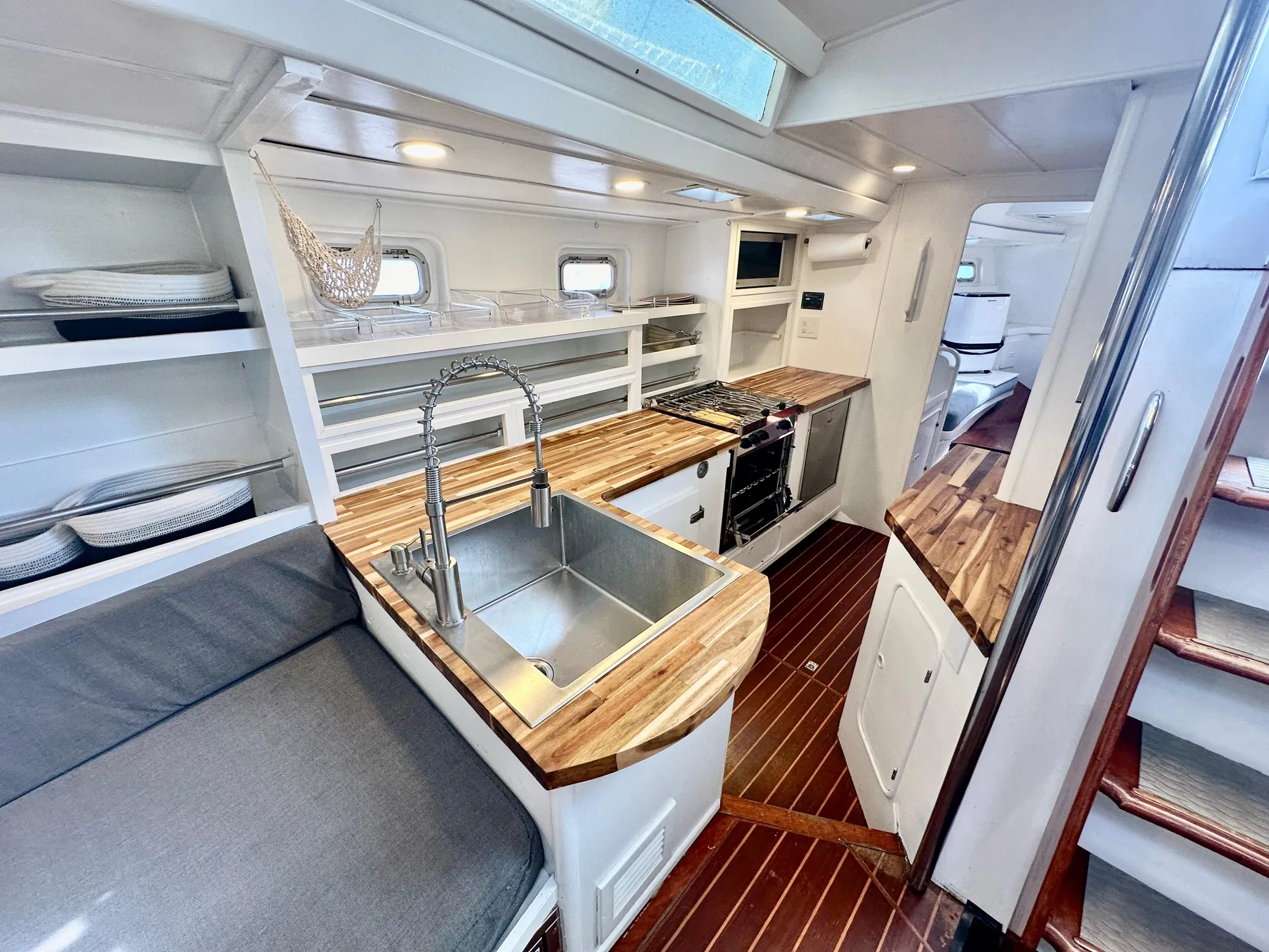 Interior of 1983 Tayana 55 yacht with modern kitchen and wooden countertops.