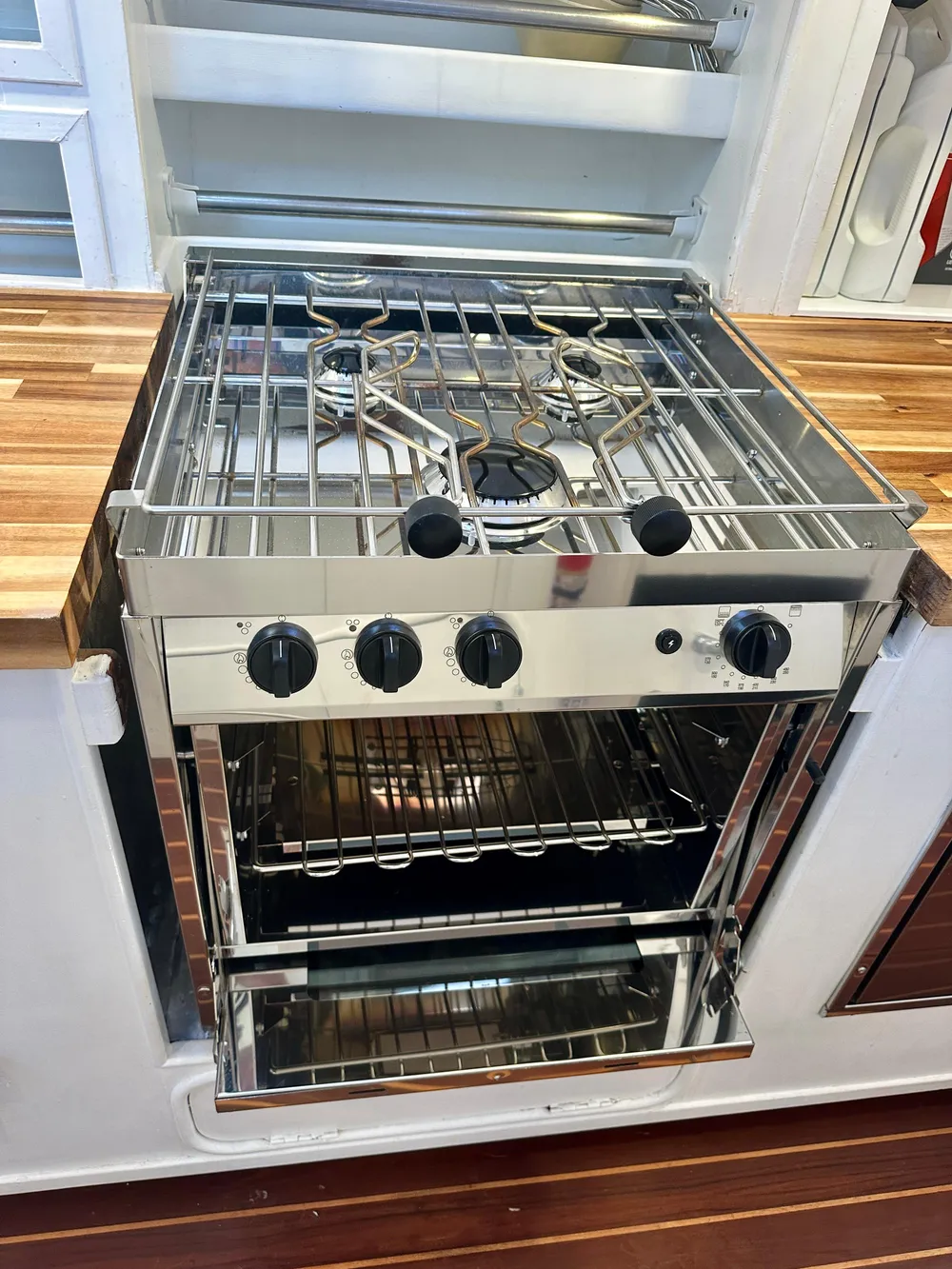 Stainless steel stove and oven in a 1983 Tayana 55 yacht kitchen.