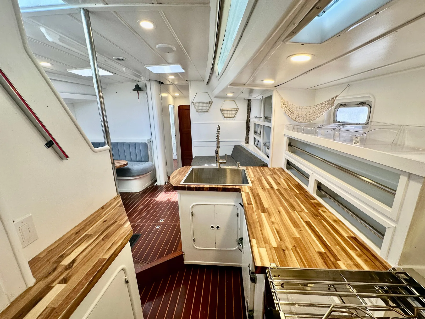 Interior of 1983 Tayana 55 yacht with modern kitchen and wooden countertops.