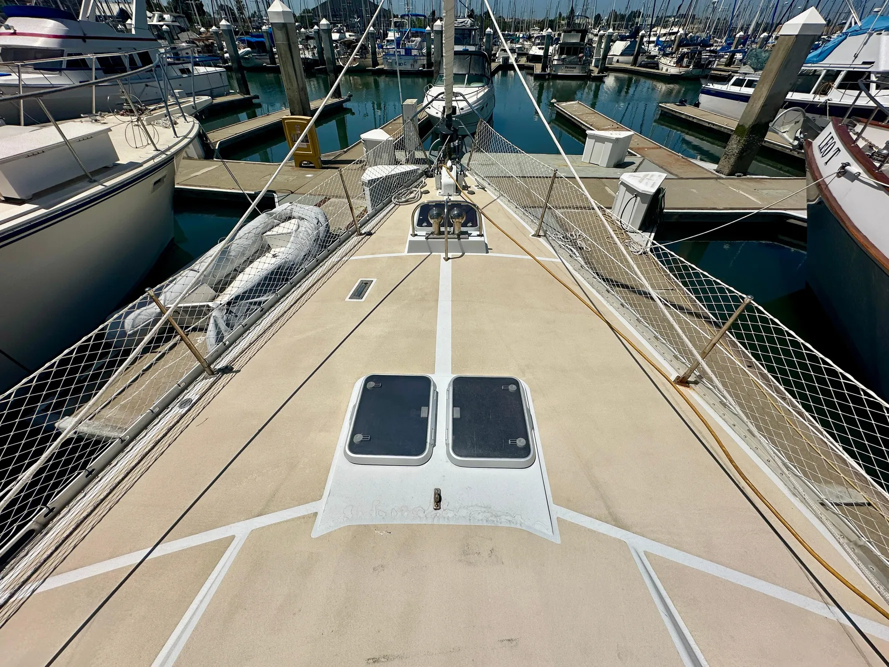 Deck view of 1983 Tayana 55 sailboat docked in a marina.
