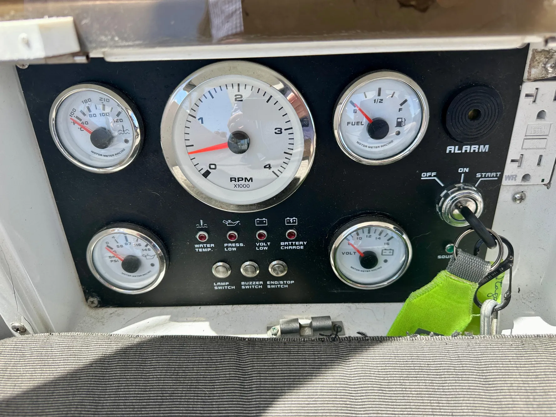 Control panel of a 1983 Tayana 55 sailboat with gauges and ignition key.