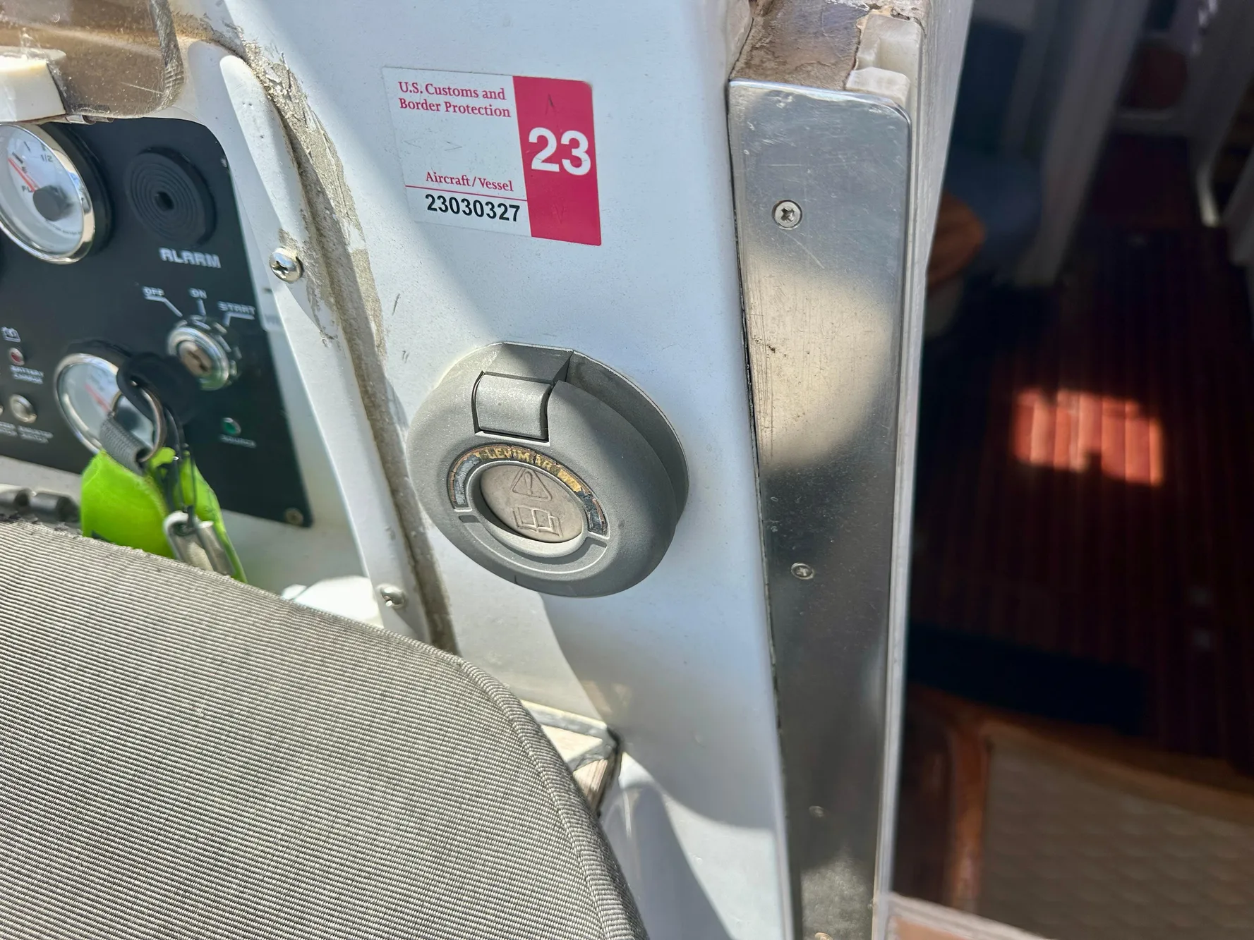 Control panel of a 1983 Tayana 55 yacht with ignition switch and customs sticker.