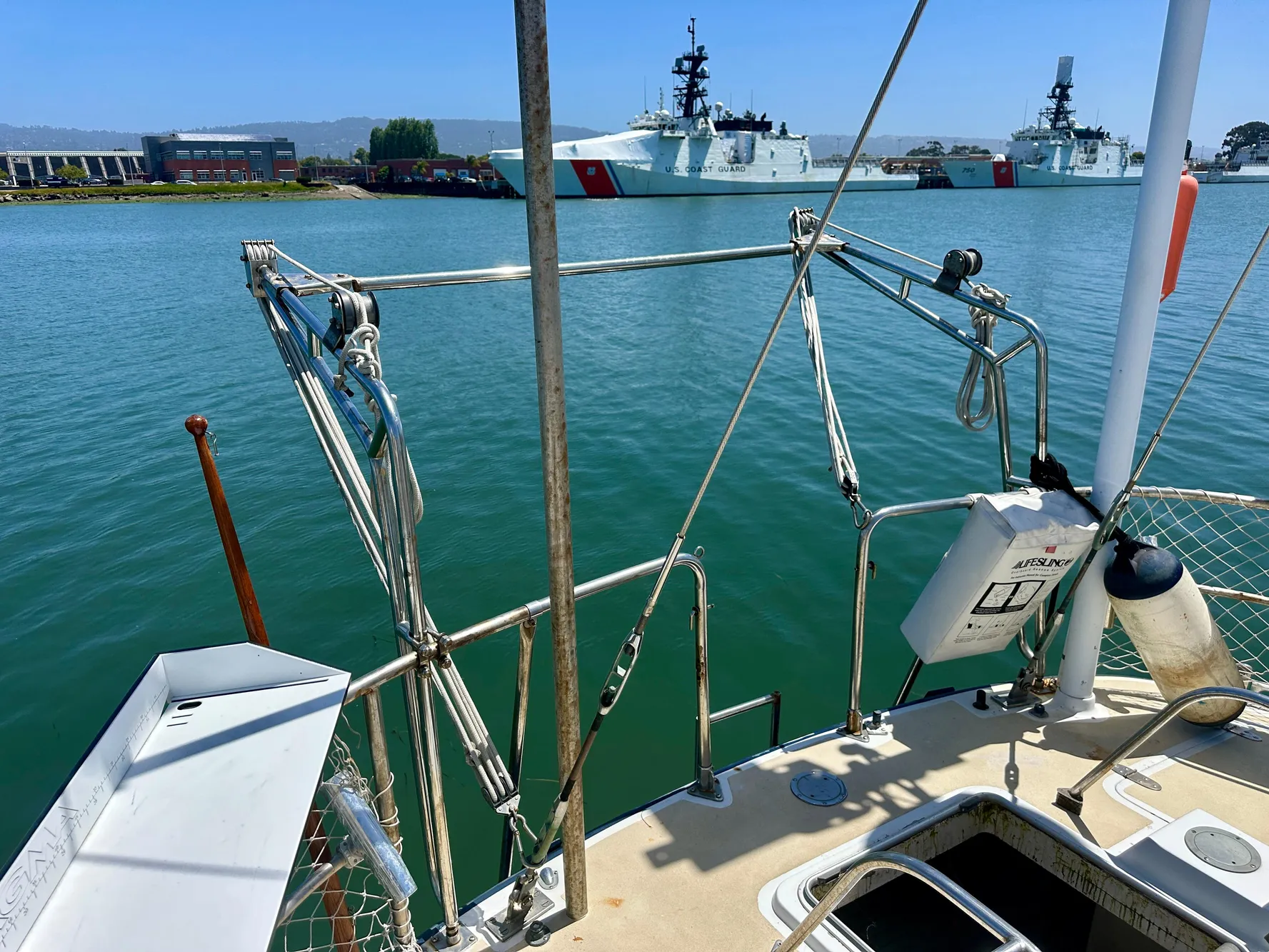 Sailboat deck view with water and ships in the background, Tayana 55, 1983 model.