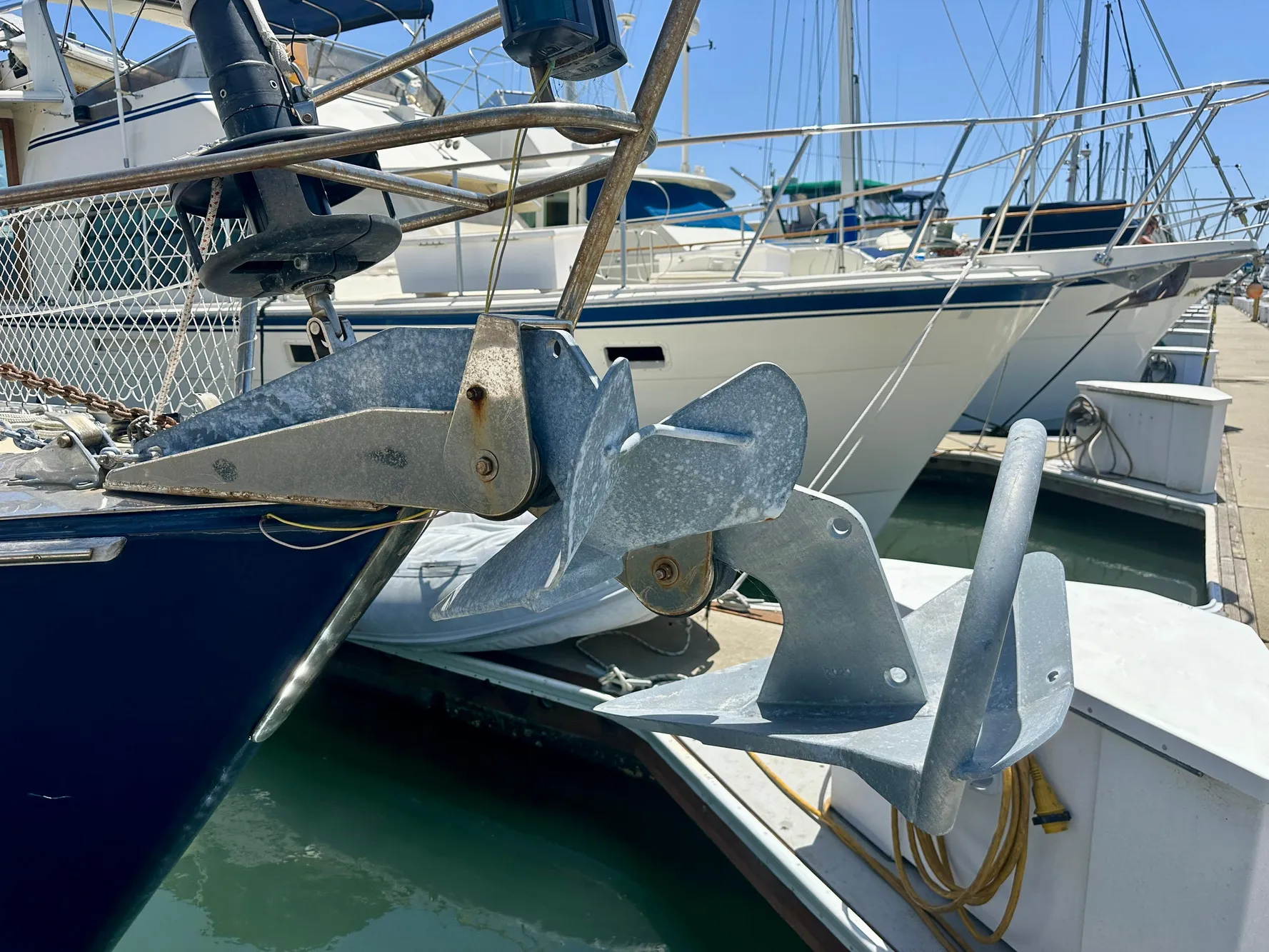 Anchor of 1983 Tayana 55 sailboat docked in marina.