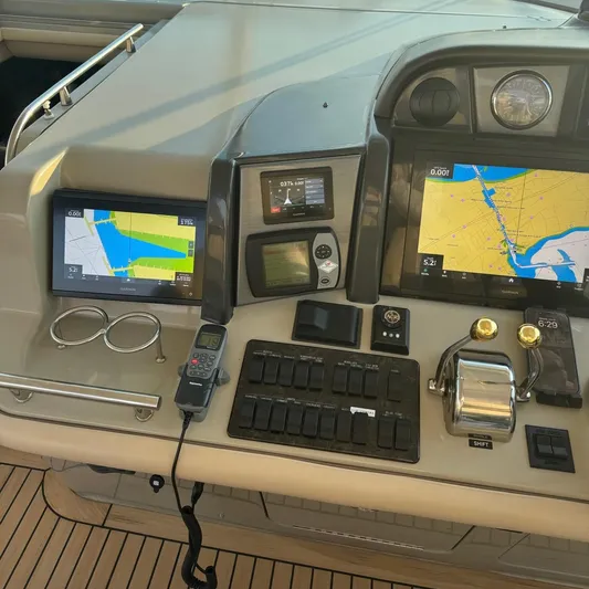 Knee Deep Yacht Photos Pics Control panel of 2006 Sea Ray 48 Sundancer with navigation screens and controls.