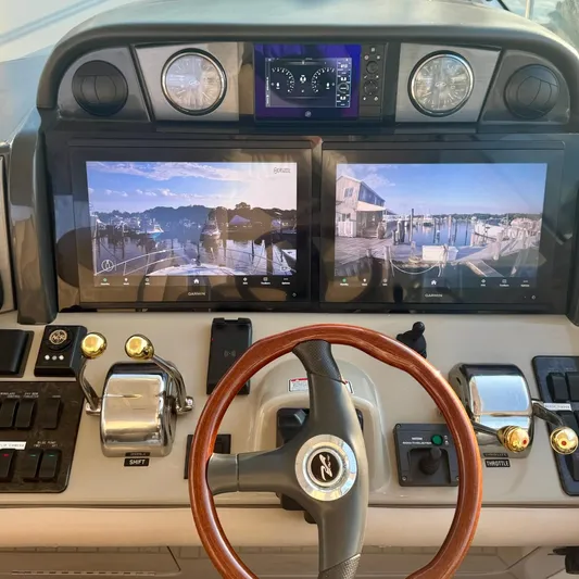 Knee Deep Yacht Photos Pics 2006 Sea Ray 48 Sundancer helm with dual Garmin displays and wooden steering wheel.