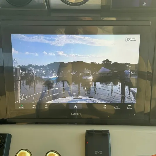 Knee Deep Yacht Photos Pics Garmin display on 2006 Sea Ray 48 Sundancer showing marina view with boats and clear sky.