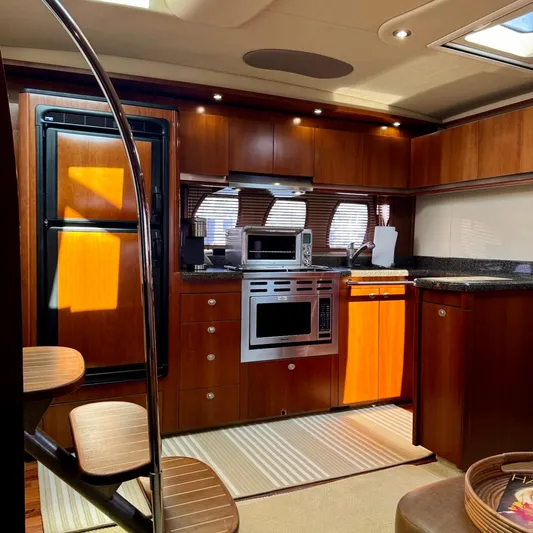 Knee Deep Yacht Photos Pics Luxurious kitchen interior of 2006 Sea Ray 48 Sundancer yacht with modern appliances.