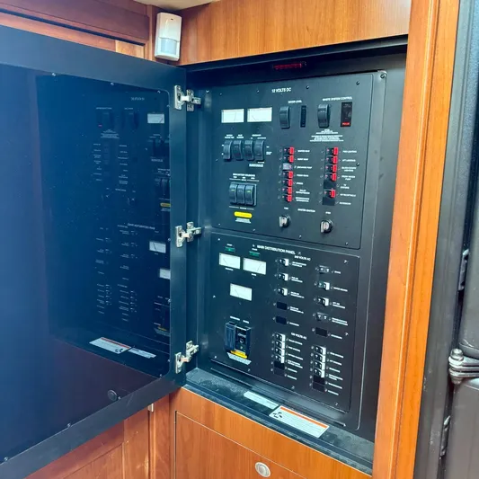 Knee Deep Yacht Photos Pics Electrical control panel inside 2006 Sea Ray 48 Sundancer yacht, featuring switches and circuit breakers.