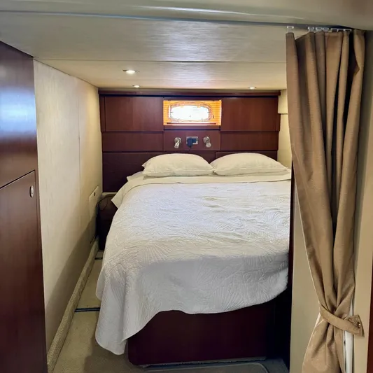 Knee Deep Yacht Photos Pics Luxurious cabin interior of 2006 Sea Ray 48 Sundancer yacht with cozy bed and elegant decor.