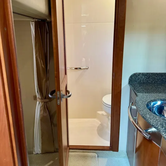 Knee Deep Yacht Photos Pics Bathroom interior of 2006 Sea Ray 48 Sundancer yacht, featuring a sink and toilet.