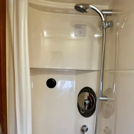 Knee Deep Yacht Photos Pics Shower area in 2006 Sea Ray 48 Sundancer yacht with chrome fixtures.