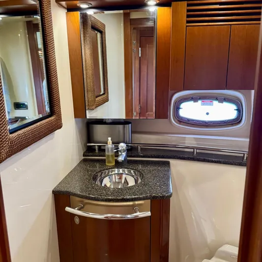Knee Deep Yacht Photos Pics Luxurious bathroom in 2006 Sea Ray 48 Sundancer yacht with wood accents and modern fixtures.