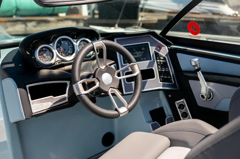  Yacht Photos Pics Interior of 2022 MasterCraft XT24 boat, featuring modern steering wheel and dashboard controls.