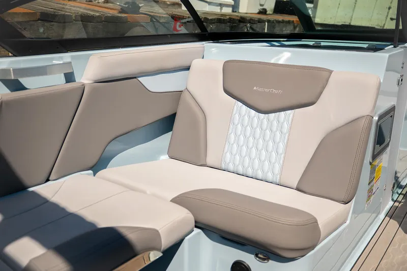  Yacht Photos Pics 2022 MasterCraft XT24 boat interior with beige and white cushioned seating.