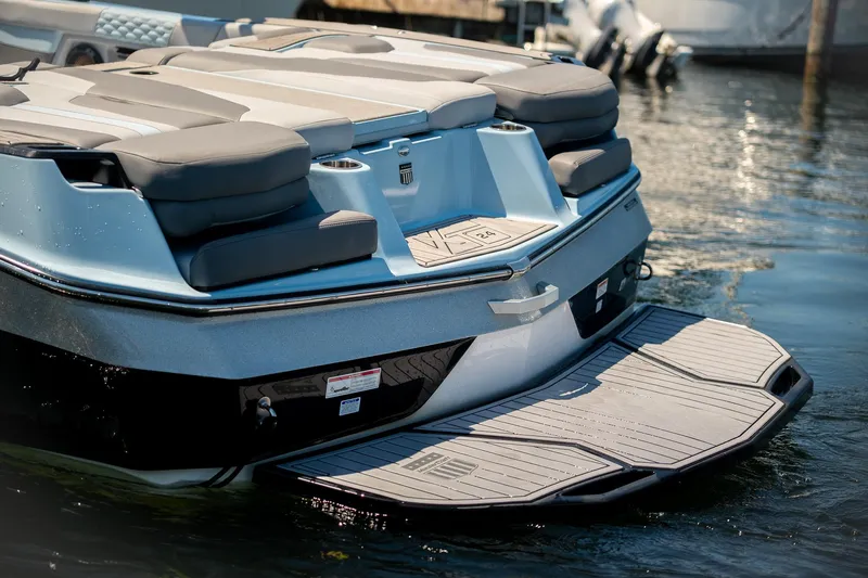  Yacht Photos Pics 2022 MasterCraft XT24 boat with swim platform on calm water.