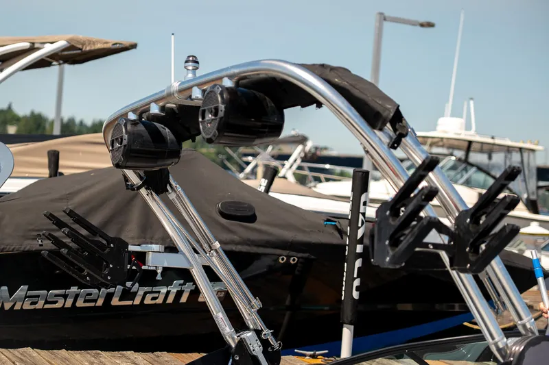  Yacht Photos Pics 2022 MasterCraft XT24 boat with wakeboard tower and speakers at a marina.