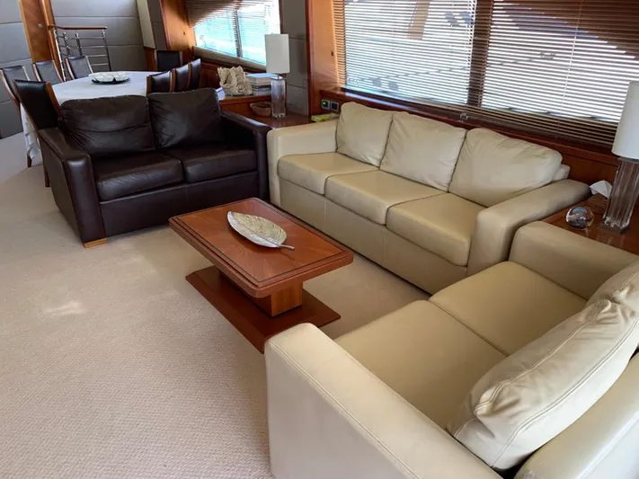 Julcan II Yacht Photos Pics Luxurious interior of 2006 Sunseeker 90 Yacht with elegant sofas and wooden accents.