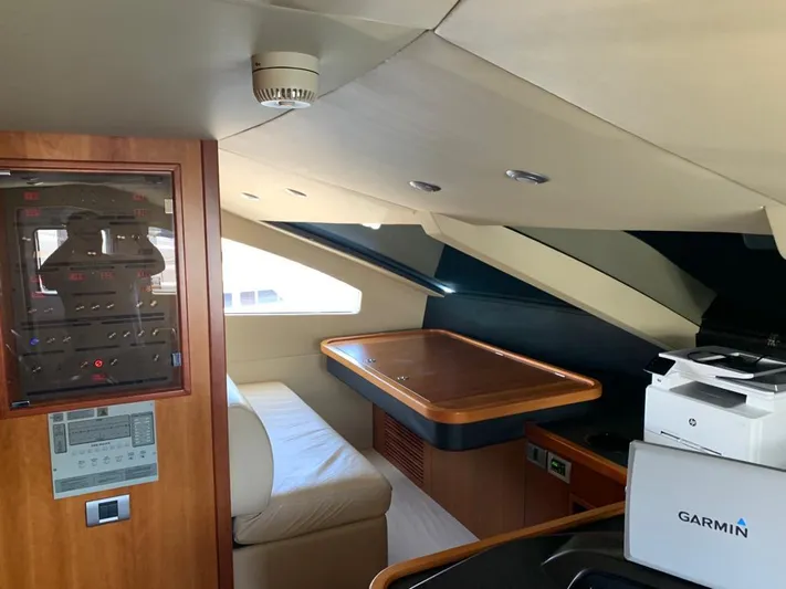 Julcan II Yacht Photos Pics Interior of 2006 Sunseeker 90 Yacht with seating, table, and Garmin equipment.