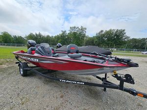 2025 Tracker Pro Team 175 boat on trailer, red and black design, parked outdoors.