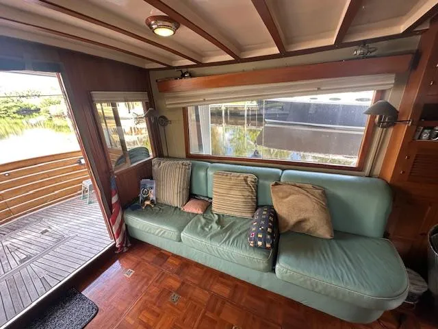 Tortuga Yacht Photos Pics Cozy interior of 1987 Kadey-Krogen 42 yacht with teal sofa and wooden flooring.