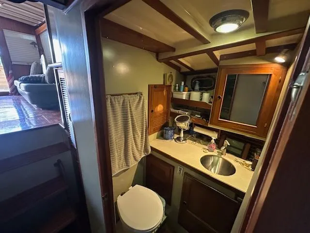 Tortuga Yacht Photos Pics Interior of 1987 Kadey-Krogen 42 yacht bathroom with sink, mirror, and toilet.