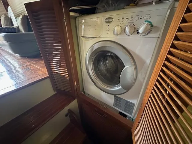Tortuga Yacht Photos Pics Washing machine inside 1987 Kadey-Krogen 42 yacht with wooden cabinetry.
