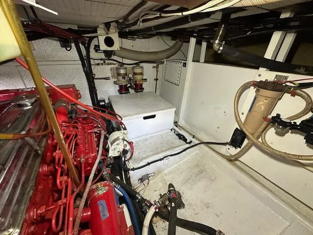 Tortuga Yacht Photos Pics Engine room of a 1987 Kadey-Krogen 42 boat, featuring red engine and fuel filters.