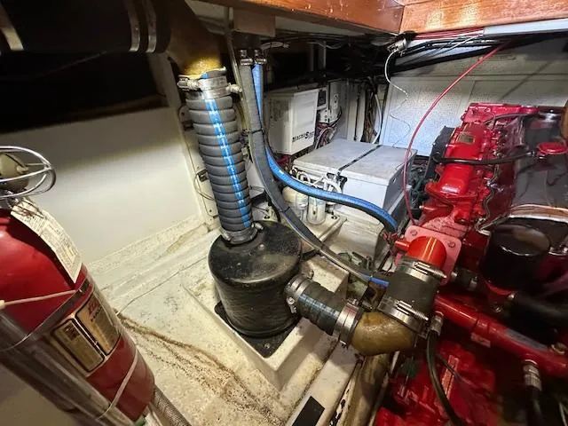 Tortuga Yacht Photos Pics Engine room of a 1987 Kadey-Krogen 42 boat, featuring mechanical components and fire extinguisher.